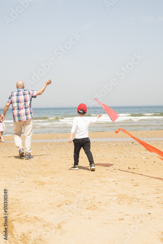Launching a flying kite on the beach