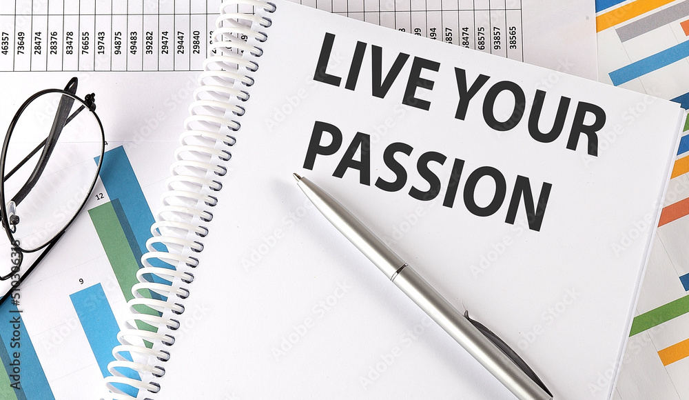 LIVE YOUR PASSION text , pen and glasses on the chart,business