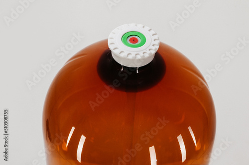 large plastic keg close-up. the canister is covered with a lid with a valve. studio photo on white background.