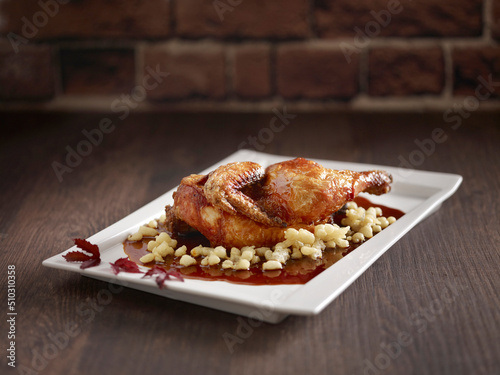 Crispy Roasted Chicken with Vinaigrette in Szechuan Style served in a dish side view on dark background