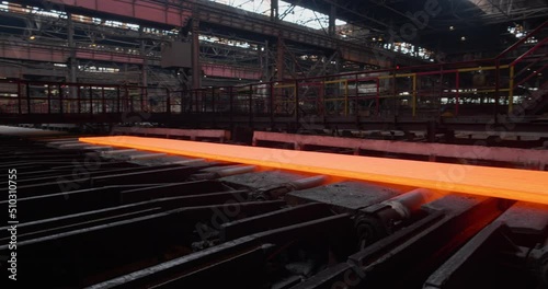 A split steel billet moves along the conveyor. Metallurgical plant. Rolling shop. Business concept, modern steel production technology.