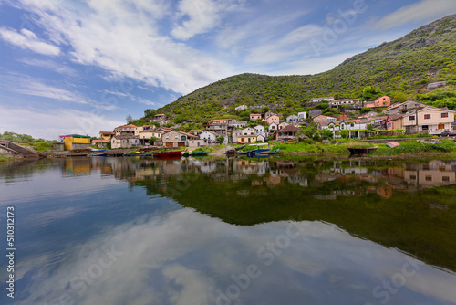 Fishing village with the the reflection of the houses in the Shkoder Lake, Montenegro © MehmetOZB