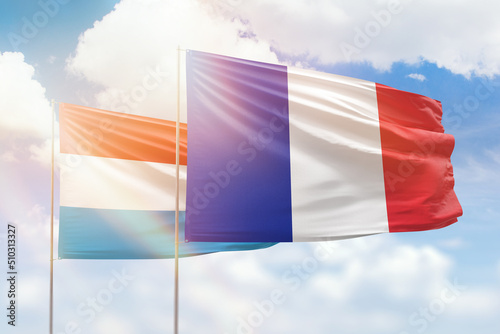 Sunny blue sky and flags of france and luxembourg