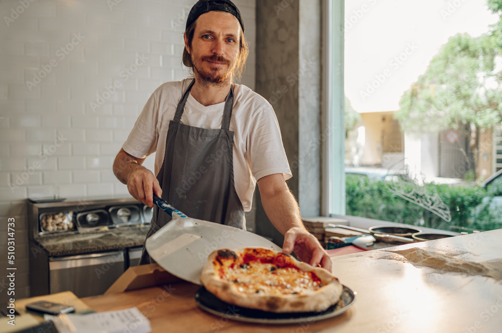 Portrait of a kitchen chef working in a pizza place