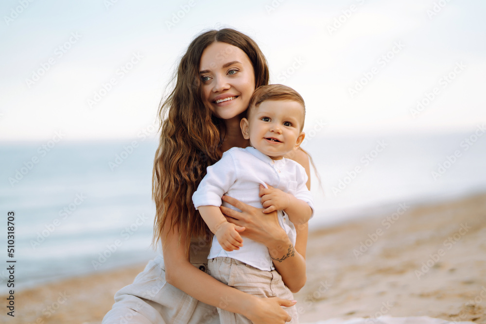 Beautiful mother and child resting on the beach. Travel, nature, active lifestyle, resort concept. Happy childhood. Beautiful mother and child resting on the beach. Travel, nature, active lifestyle, resort concept. Happy childhood.