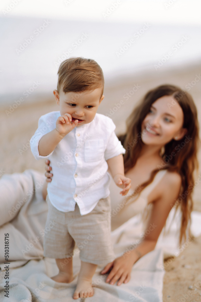 Beautiful mother and child resting on the beach. Travel, nature, active lifestyle, resort concept. Happy childhood. Beautiful mother and child resting on the beach. Travel, nature, active lifestyle, resort concept. Happy childhood.