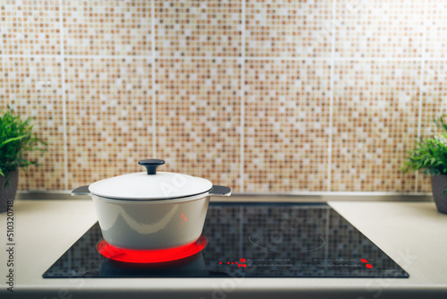 white pot on electrical induction cooktop