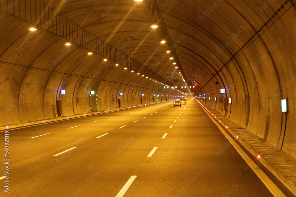 Highway vehicle tunnel inside. Multi-lane road tunnel