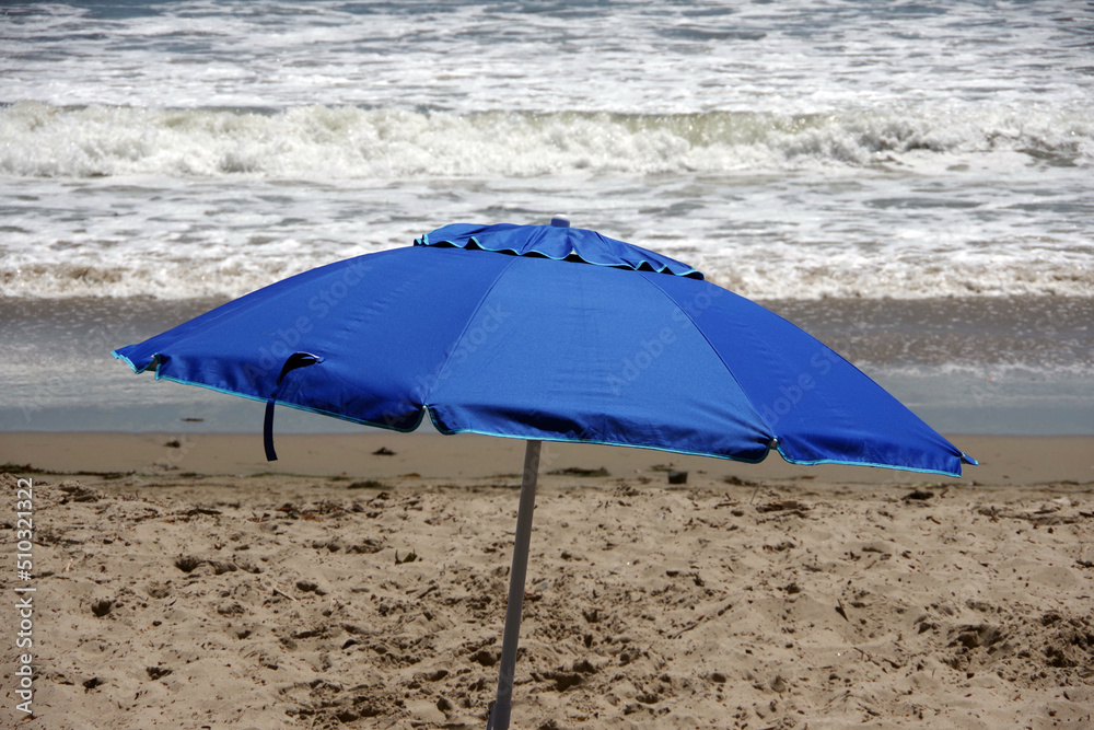 Blue umbrella at the ocean beach