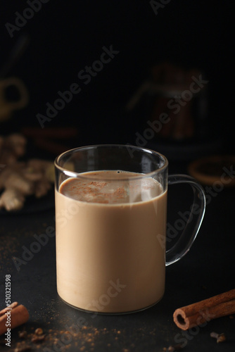 A cup with masala chai in low key