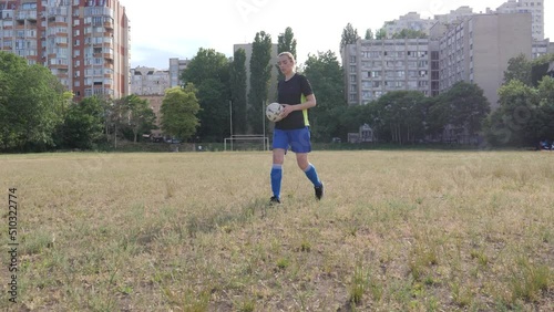 girl football player puts the ball for a free kick in the style of Cristiano Ronaldo photo