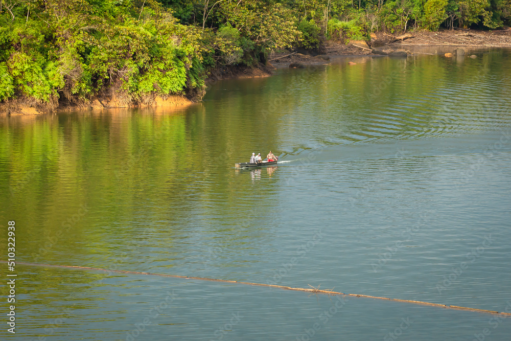 San Carlos, Antioquia, Colombia. November 11, 2020. People fishing the river by canoe San Carlos, Antioquia, Colombia. November 11, 2020. People fishing the river by canoe