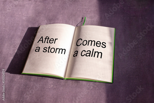 An open notebook is on the gray background. The words 