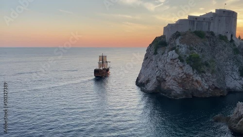 Pirate galleon ship sailing the Dubrovnik harbor at sunset