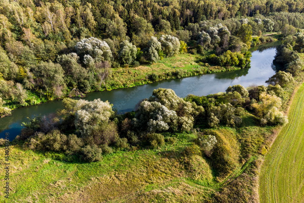 The Protva river flowing between the forest and fields near the village of Krivskoye, Kaluzhskiy region, Russia The Protva river flowing between the forest and fields near the village of Krivskoye, Kaluzhskiy region, Russia