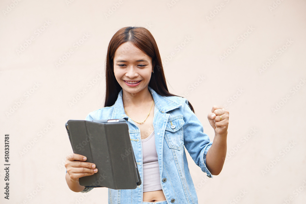 Asian women happily use portable computers. because the operating results are more profitable Asian women happily use portable computers. because the operating results are more profitable