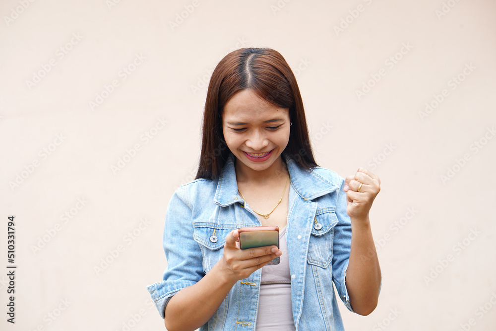 Asian women happily use their phones. because the operating results are more profitable Asian women happily use their phones. because the operating results are more profitable