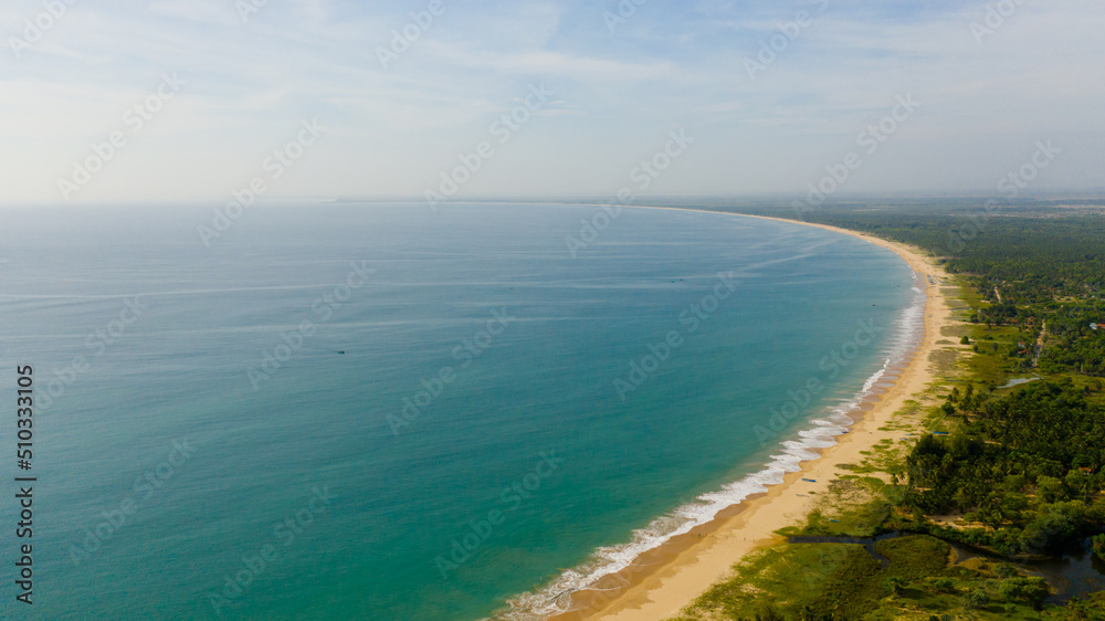 Beautiful beach, palm trees by turquoise water view from above. Kalkudah Beach, Sri Lanka.