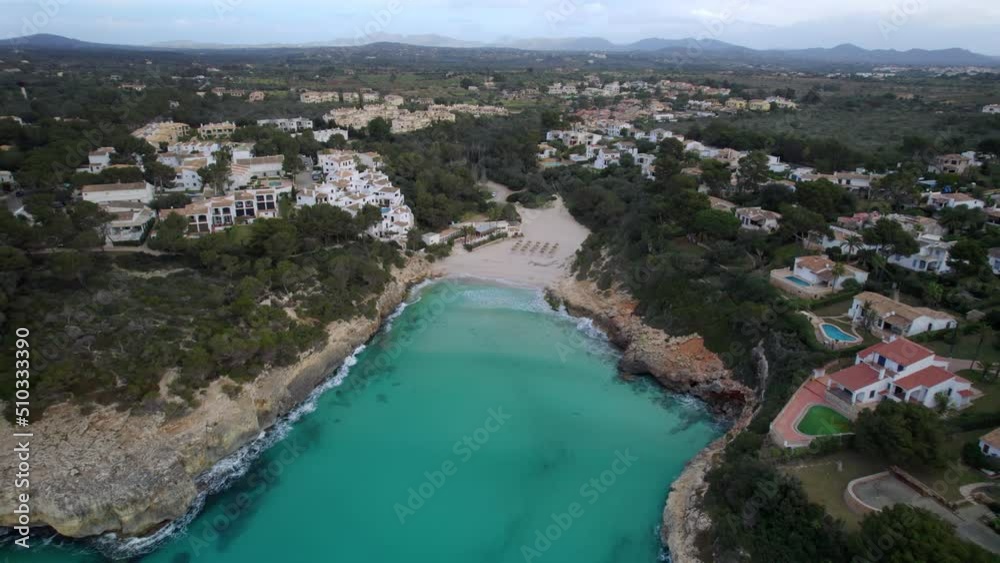 Flying over a large holiday resort and stunning blue waters of Cala Anguila Flying over a large holiday resort and stunning blue waters of Cala Anguila