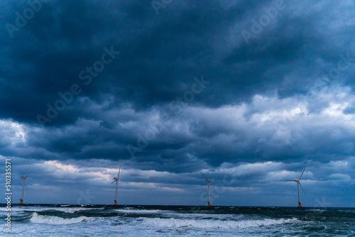 standing wind turbines against rough waves   Sinchang wind turbine generators   Hangyeong-myeon  Jeju-si  Jeju-do  South Korea