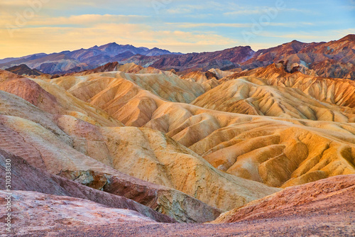 Stunning sunrise at Zabriskie Point in Death Valley with colorful sediment formations photo