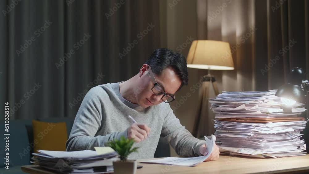 Happy Asian Man Celebrating Finishing Working With Documents At Home
