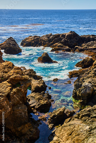Tide pool on ocean surrounded by cliffs