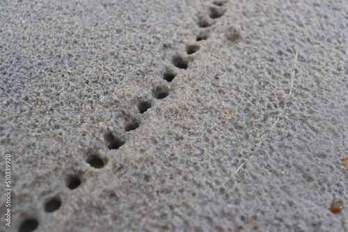 water droplets form a hole in the fine sand. natural background