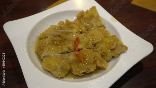 closeup of a chaufa rice dish with chijaukay chicken, typical peruvian food in a chifa chinese restaurant at night in 4k photo