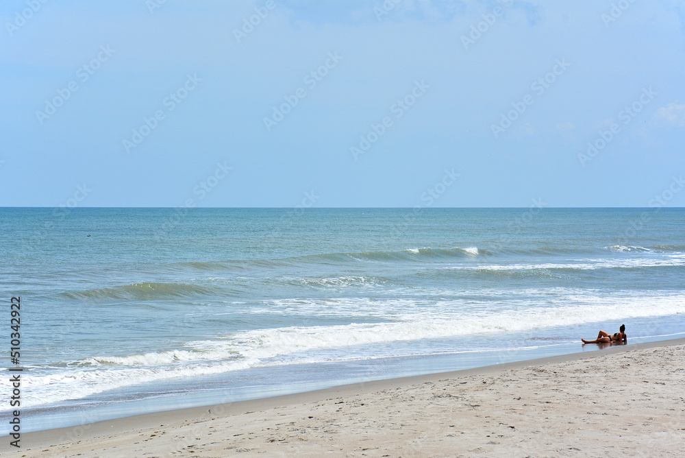 Woman relaxing on the sand in Cocoa Beach, Florida