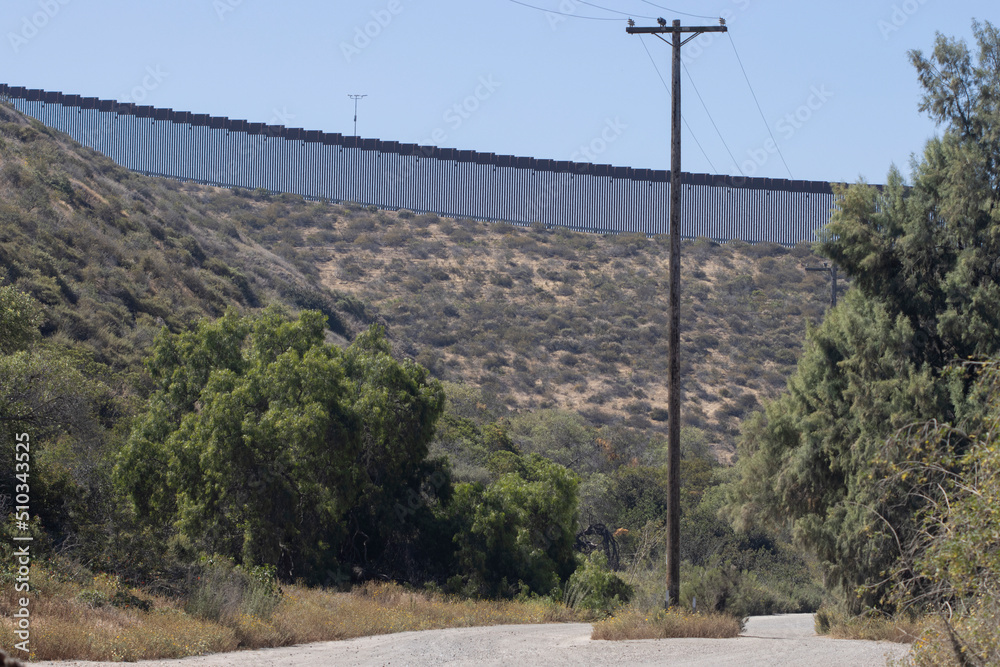 A vertical border wall between the United States and Mexico, separating San Diego from Tijuana, viewed from Tijuana River Valley, a rural community in the southern section of San Diego, California.
