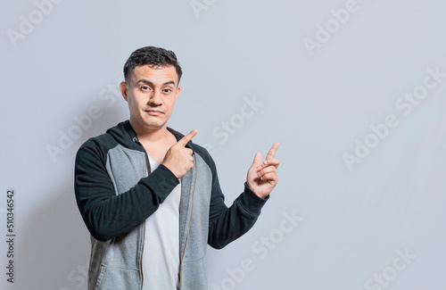 Smiling handsome man recommending something with fingers isolated, isolated people pointing fingers at something, Smiling person pointing fingers to the side