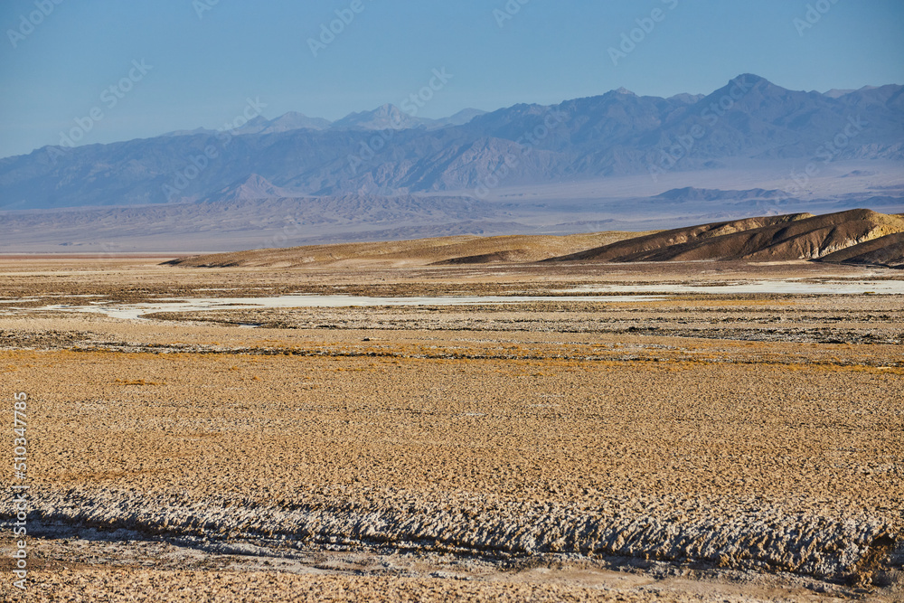 Open desert plains with mountains in distance