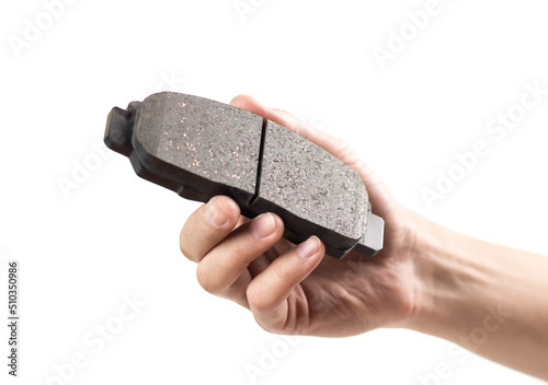 Wallpaper Mural The hand holds a new brake pad. Close up. Isolated on a white background Torontodigital.ca
