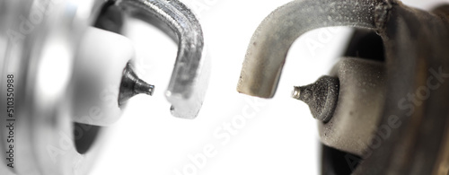 New and used iridium spark plugs. Close up. Isolated on a white background