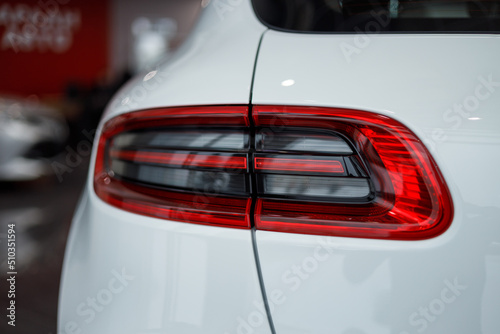 Detail on the rear light of a car. Car detail. Developed Car's rear brake light. The car is in the showroom. Automotive concept. Classic white color. The car is in the showroom. LED light
