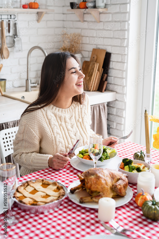 woman having thanksgiving dinner at home kitchen celebrating holiday