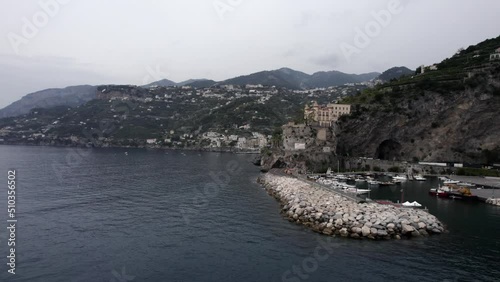 Video with Drone of empty descriptive plane at the height of the road next to the sea that leads to Minori, starting in Maiori, The Amalfi Coast, Italy. Time of transit with vehicles, cyclists. photo