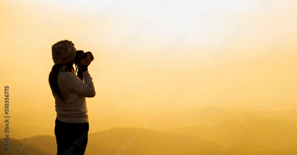 Silhouette Asian woman Nature photographer,Beautiful background at sunset