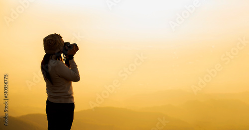 Silhouette Asian woman Nature photographer,Beautiful background at sunset