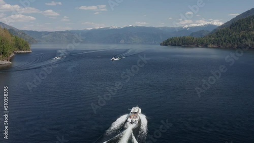 A pleasure boat goes along a picturesque lake on a sunny summer day
