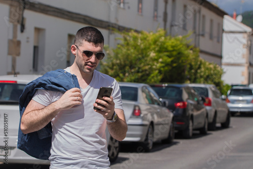 casual young man on the street with mobile phone