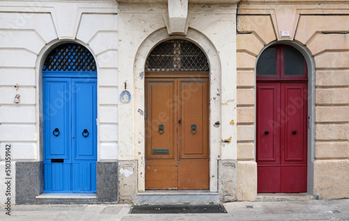 Traditional vintage painted wooden door in Malta. Popular travel destination. Entrance to house. Exterior of typical houses on the Mediterranean island of Malta - April, 2022. © Yuliya