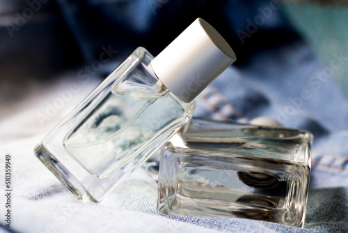 Women's and men's perfume on denim