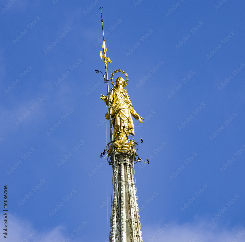 Virgin Mary statue called Madonnina on the highest point of the Duomo cathedral.Milan, Italy Virgin Mary statue called Madonnina on the highest point of the Duomo cathedral.Milan, Italy