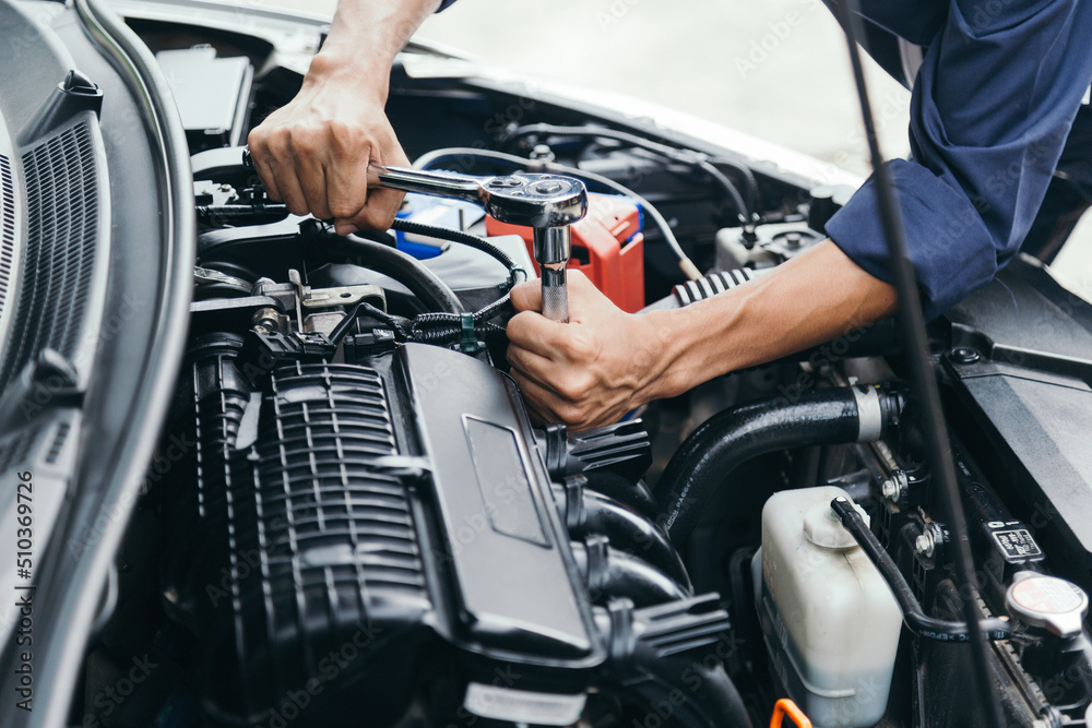 Automobile mechanic repairman hands repairing a car engine automotive workshop with a wrench, car service and maintenance,Repair service.