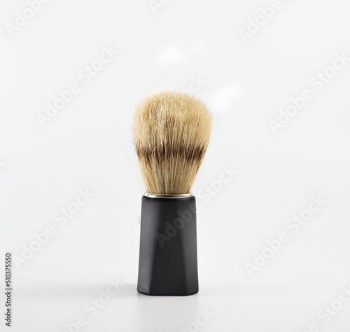 boar bristle shaving brush with black handle on white background