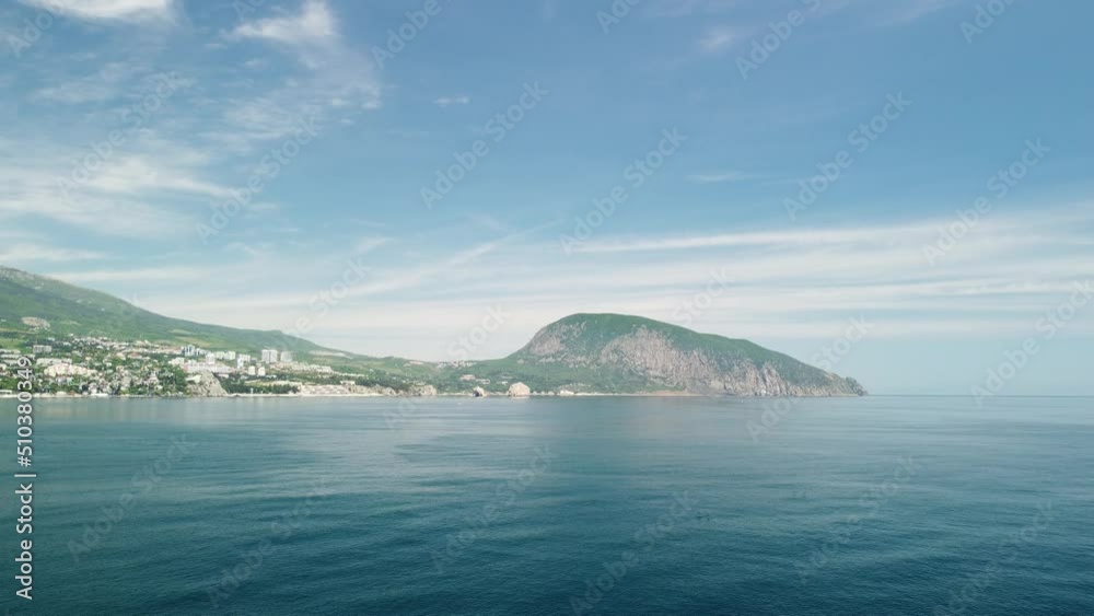 Gurzuf resort city panoramic view on Bear Mountain, Ayu-Dag, Yalta, Crimea. Spring sunny day. Nature summer ocean sea beach background. Vacation, travel and holiday concept. Gurzuf resort city panoramic view on Bear Mountain, Ayu-Dag, Yalta, Crimea. Spring sunny day. Nature summer ocean sea beach background. Vacation, travel and holiday concept.