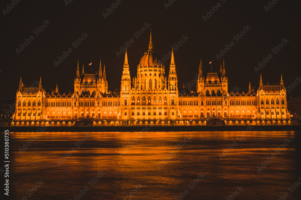 Hungarian parliament building from across the Danube river at night Budapest Hungary