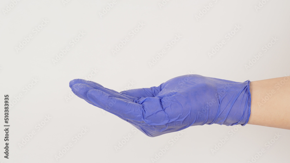 Empty hand wear violet latex glove doing sign for help on white background. side view